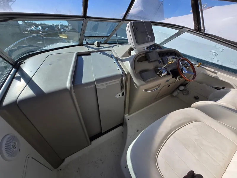 Slide: The Image of 2000 Sea Ray 310 Sundancer boat interior with steering wheel and dashboard. - 33