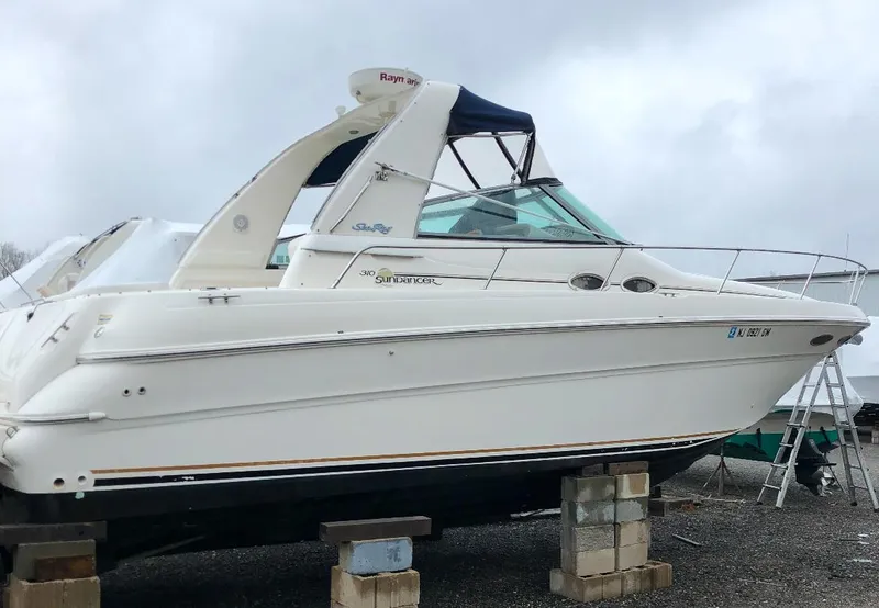 Slide: The Image of 2000 Sea Ray 310 Sundancer boat on blocks, side view. - 35