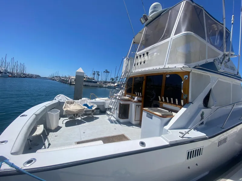 Slide: The Image of 1979 Pacifica 44 Flybridge interior with seating and helm, docked at marina. - 4