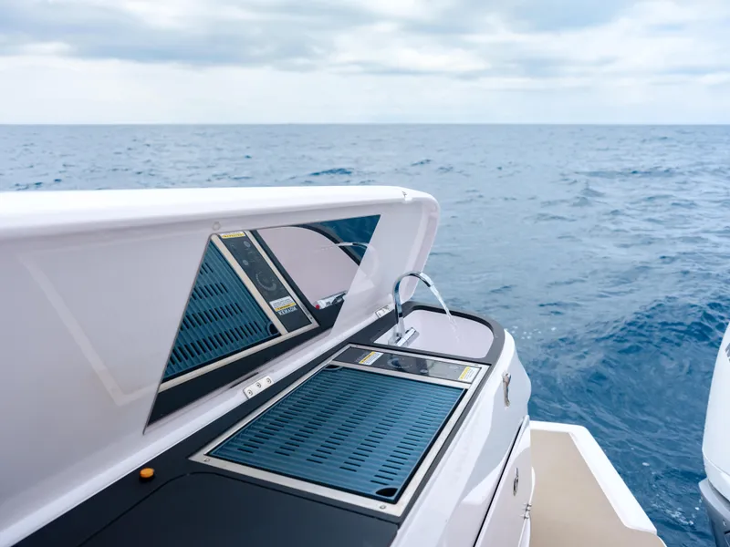 Slide: The Image of 2025 Axopar 45 SUN TOP boat with sleek deck design on open sea. - 15