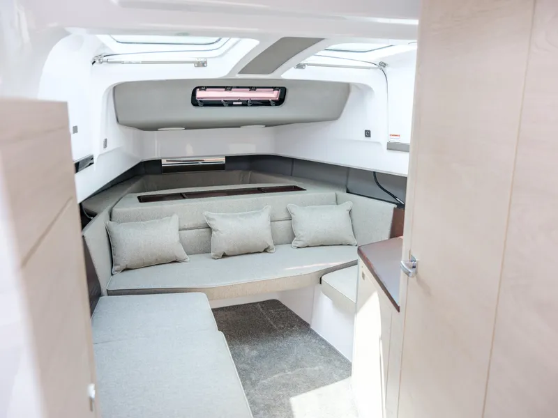 Slide: The Image of Interior of 2025 Axopar 45 SUN TOP boat, featuring modern seating and sleek design. - 17