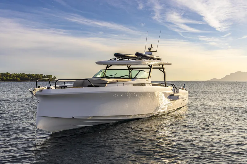 Slide: The Image of 2025 Axopar 45 SUN TOP boat on calm water, scenic horizon in background. - 3