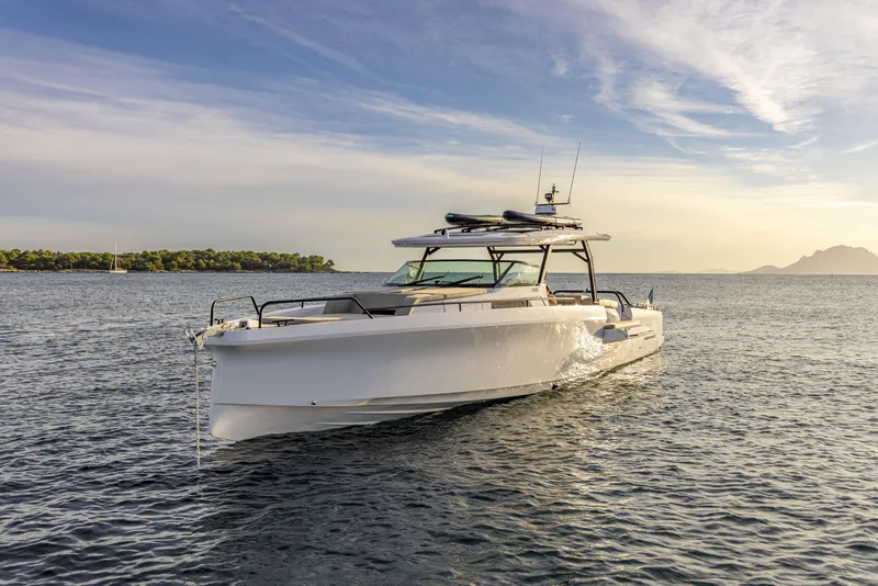 Slide: The Image of 2025 Axopar 45 SUN TOP boat on calm water under a clear sky. - 6