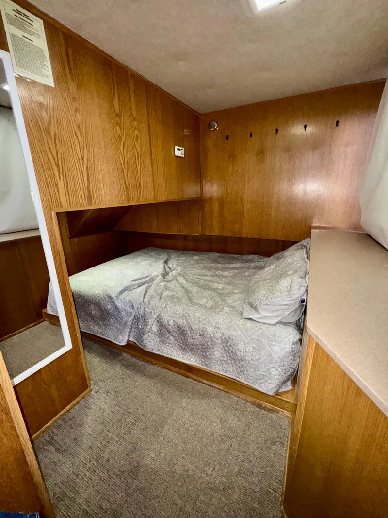 Slide: The Image of Cozy bedroom in 1997 Sumerset Johnny Quest Trip #33 houseboat with wood paneling and bed. - 10