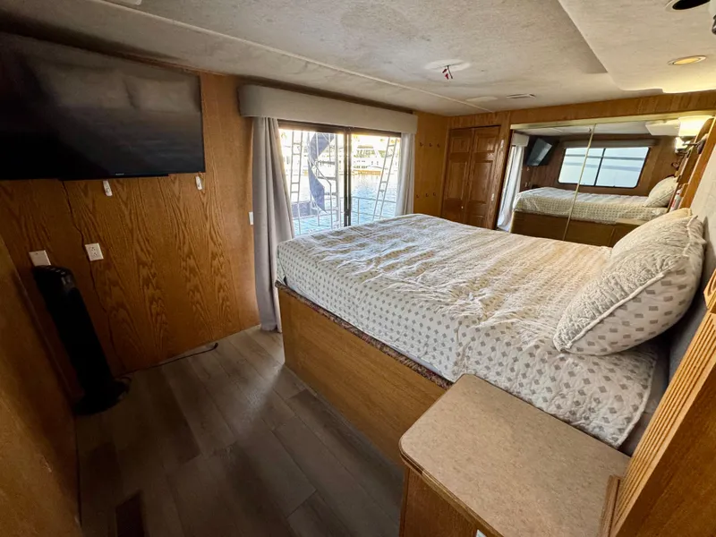 Slide: The Image of Bedroom interior of 1997 Sumerset Johnny Quest Trip #33 houseboat with bed and TV. - 16