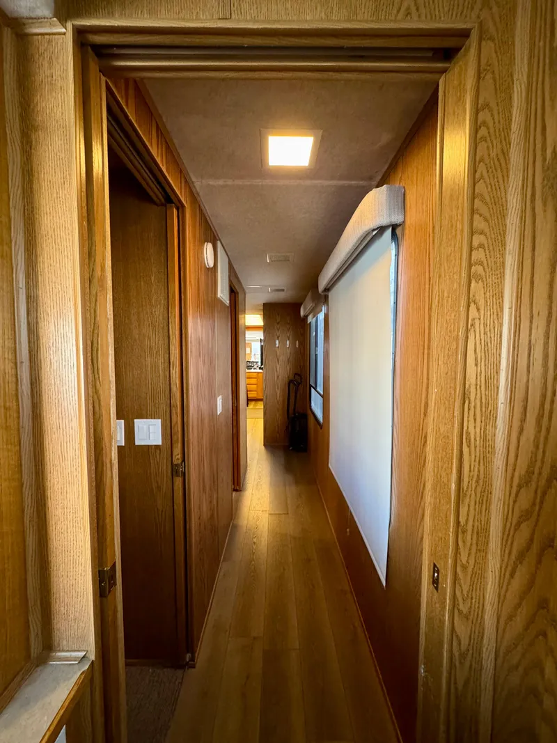 Slide: The Image of Narrow hallway in a 1997 Sumerset Johnny Quest Trip #33 houseboat with wooden paneling. - 18