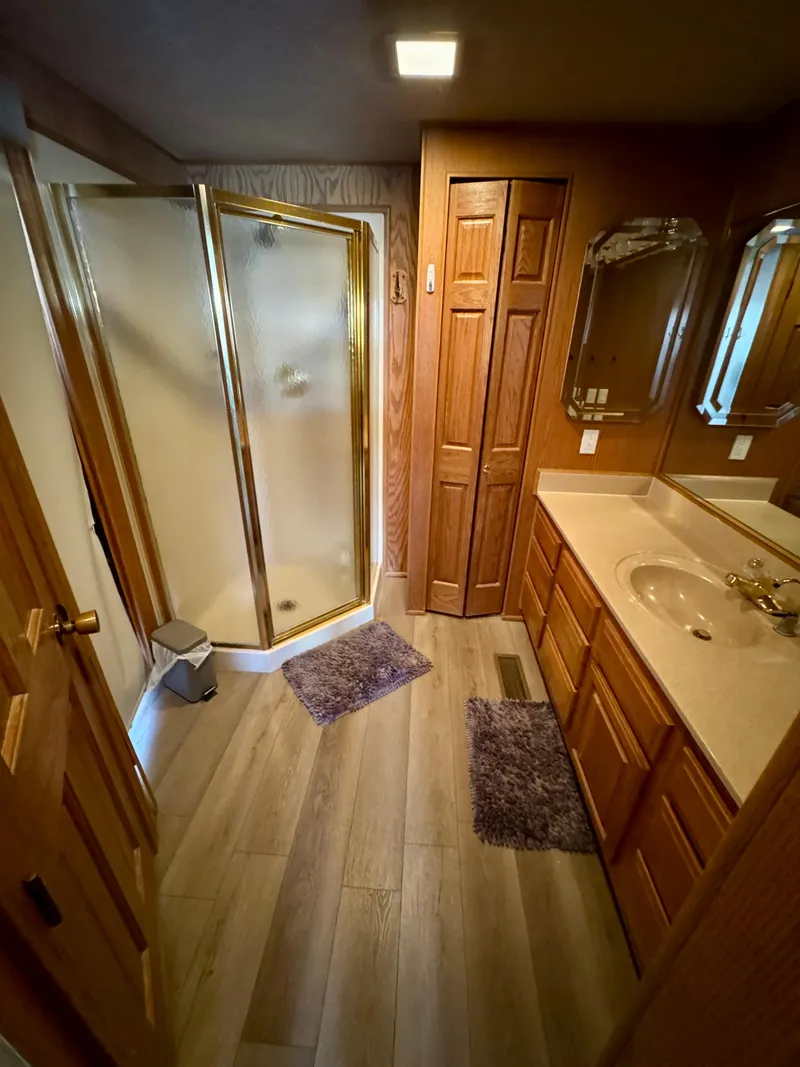 Slide: The Image of 1997 Sumerset Johnny Quest Trip #33 bathroom with wood accents and corner shower. - 19