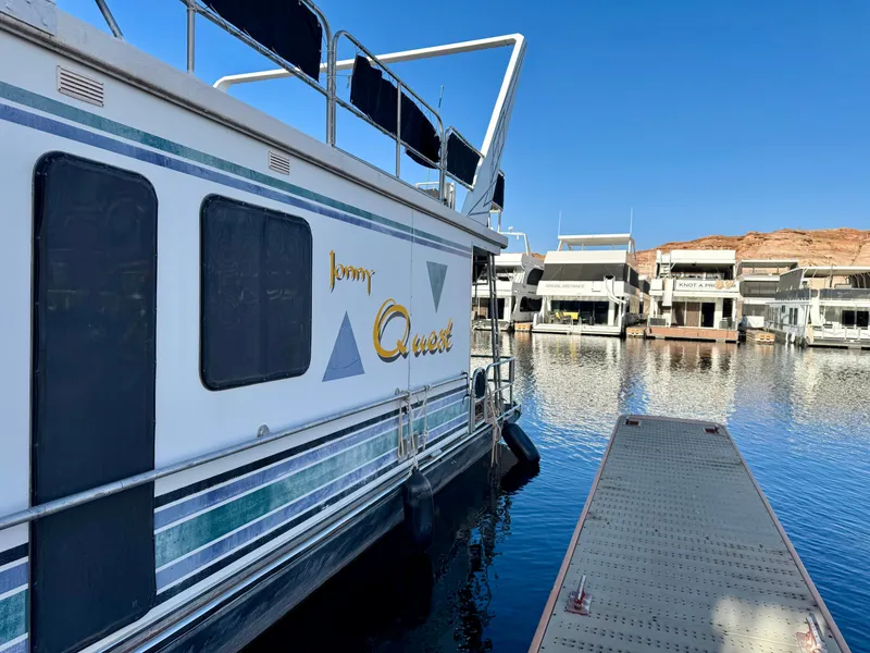 Slide: The Image of Houseboat "Johnny Quest Trip #33" by Sumerset, 1997, docked at a marina. - 2