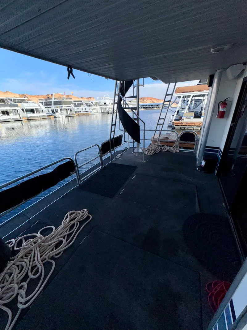 Slide: The Image of 1997 Sumerset Johnny Quest Trip #33 houseboat deck with marina view and mooring ropes. - 20