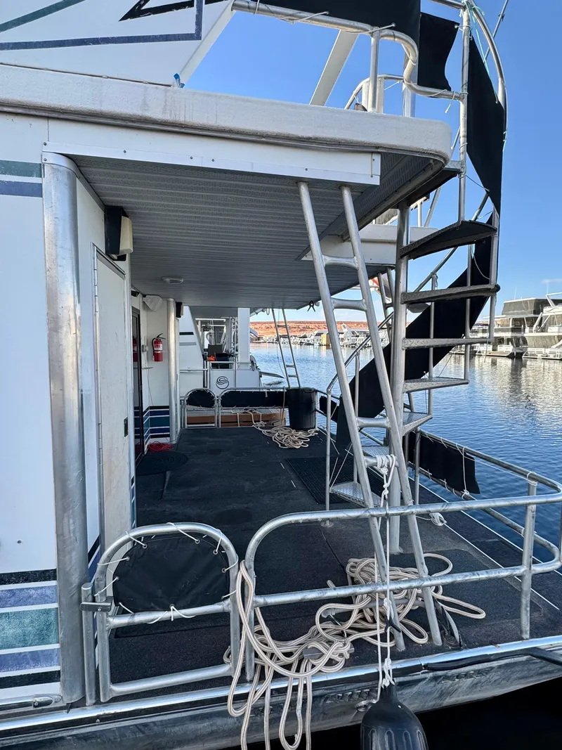 Slide: The Image of 1997 Sumerset Johnny Quest Trip #33 houseboat with spiral staircase and docked at marina. - 23