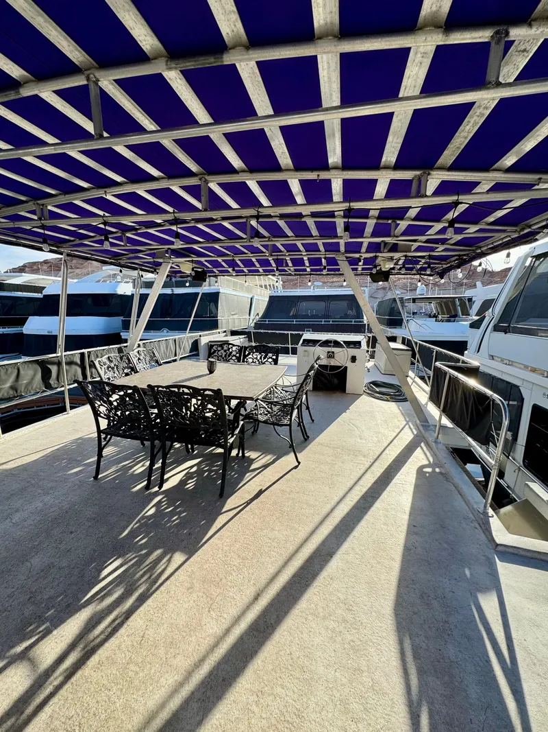 Slide: The Image of 1997 Sumerset Johnny Quest Trip #33 houseboat with shaded deck and outdoor dining area. - 24