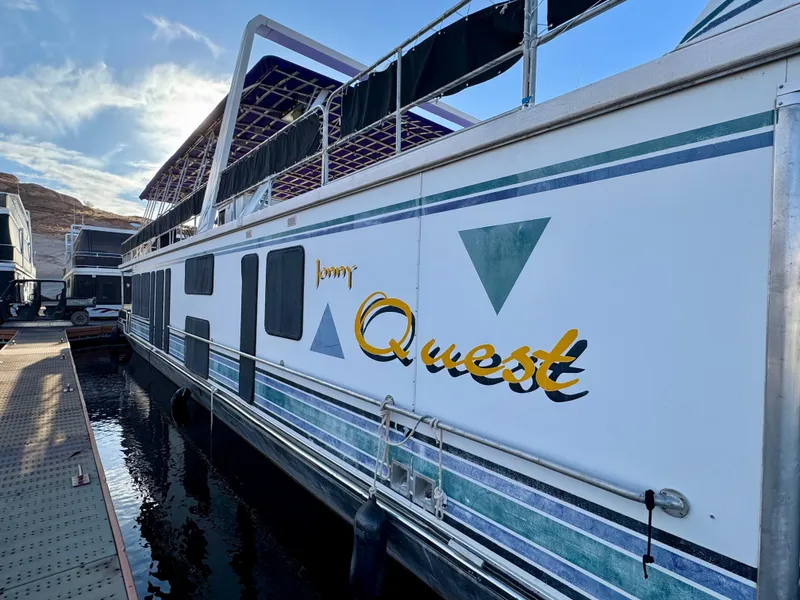 Slide: The Image of 1997 Sumerset Johnny Quest Trip #33 houseboat docked on a sunny day. - 3