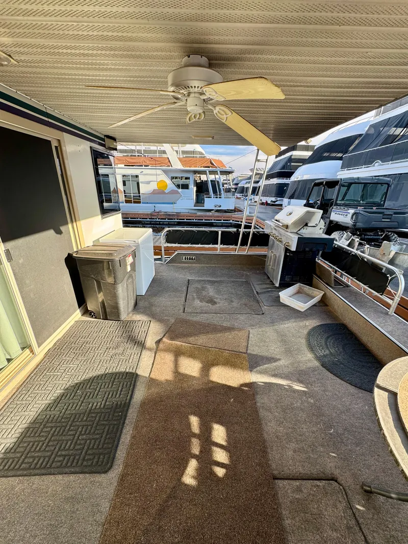 Slide: The Image of 1997 Sumerset Johnny Quest Trip #33 houseboat deck with ceiling fan and outdoor amenities. - 5