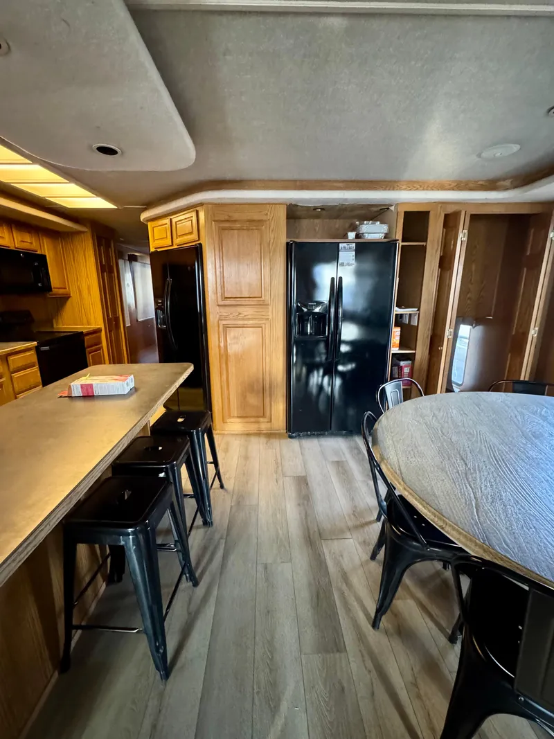 Slide: The Image of Kitchen interior of 1997 Sumerset Johnny Quest Trip #33 with modern appliances and seating. - 7