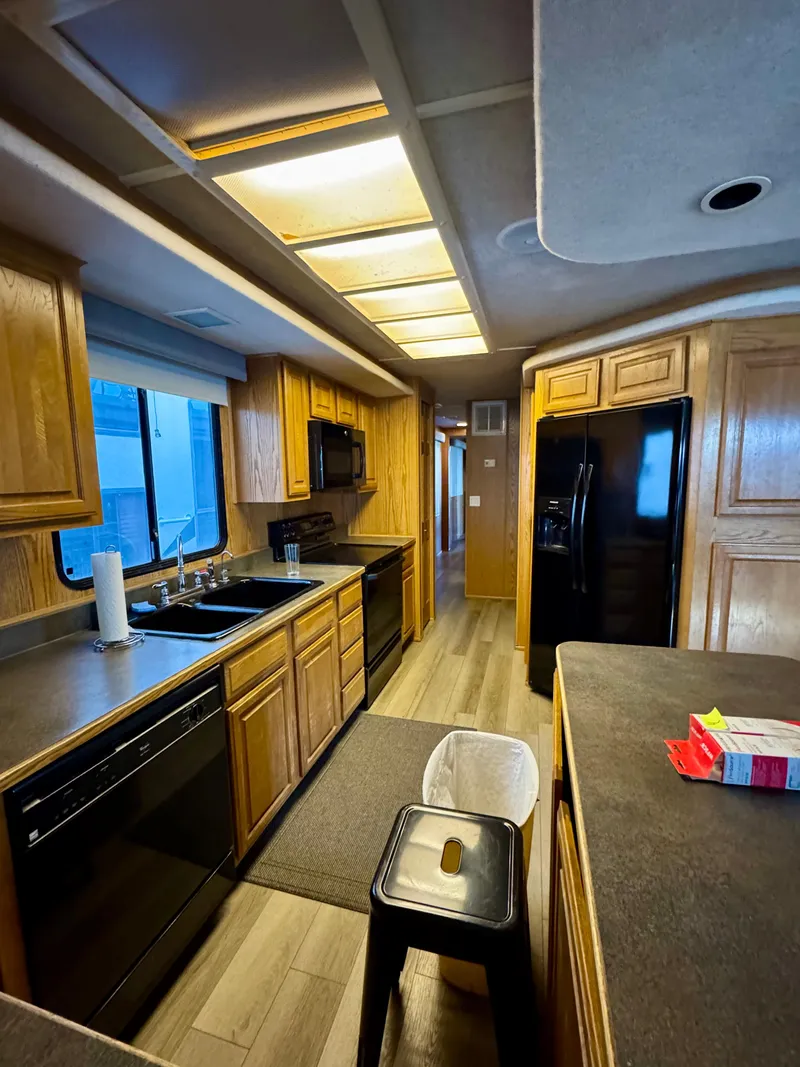 Slide: The Image of Spacious kitchen in 1997 Sumerset Johnny Quest Trip #33 houseboat with wooden cabinets and modern appliances. - 8