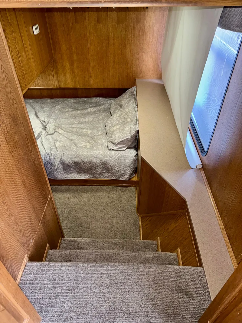 Slide: The Image of Cozy cabin interior of 1997 Sumerset Johnny Quest Trip #33 with bed and stairs. - 9