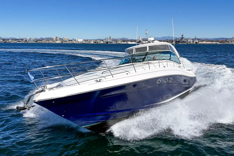 Slide: The Image of 2005 Sea Ray 500 Sundancer yacht cruising on open water, creating a dynamic wake. - 20