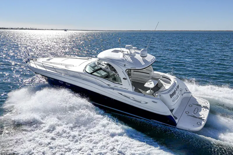 Slide: The Image of 2005 Sea Ray 500 Sundancer cruising on open water under clear skies. - 22