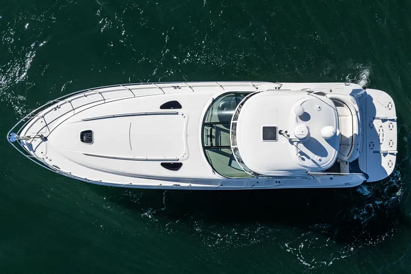 Slide: The Image of Top view of a 2005 Sea Ray 500 Sundancer yacht cruising on water. - 25