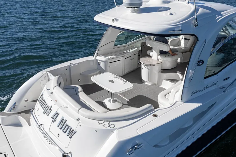 Slide: The Image of 2005 Sea Ray 500 Sundancer yacht with spacious deck and seating on the water. - 35