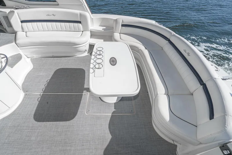 Slide: The Image of Luxurious 2005 Sea Ray 500 Sundancer yacht deck with elegant seating and table, overlooking the ocean. - 38