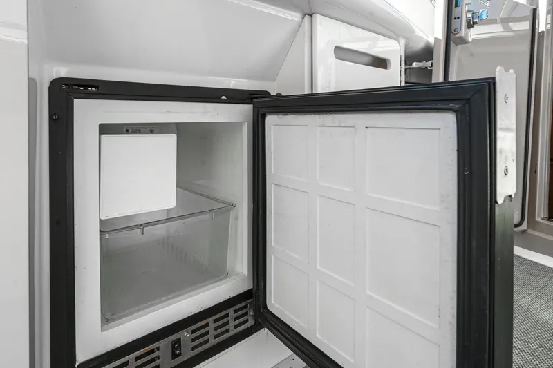 Slide: The Image of Open refrigerator on 2005 Sea Ray 500 Sundancer yacht, showcasing interior storage space. - 41