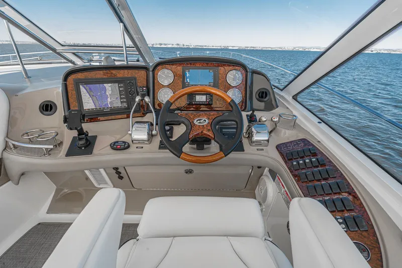 Slide: The Image of Helm of 2005 Sea Ray 500 Sundancer yacht with navigation instruments and steering wheel. - 48