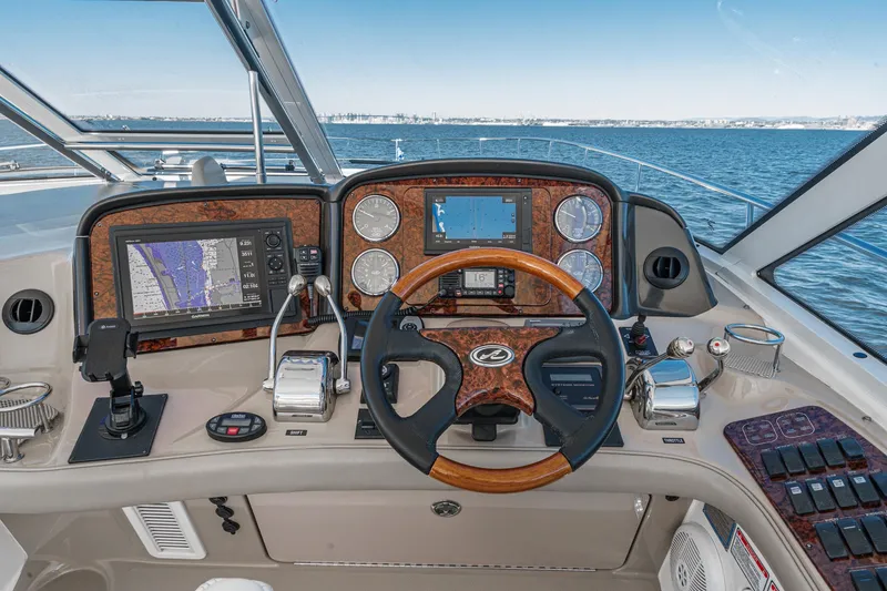 Slide: The Image of 2005 Sea Ray 500 Sundancer helm with navigation controls and ocean view. - 49