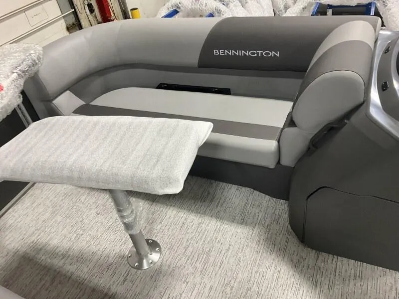 Slide: The Image of 2025 Bennington 20 S STERN RADIUS boat interior with cushioned seating and table. - 6