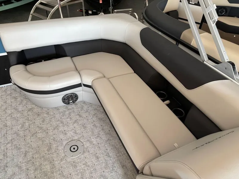 Slide: The Image of 2024 South Bay 200 Series S222CR2 boat interior with beige seating and carpeted floor. - 3