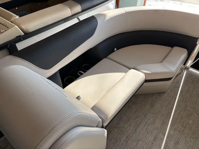 Slide: The Image of 2024 South Bay 200 Series S222CR2 boat interior with plush seating and cup holders. - 7
