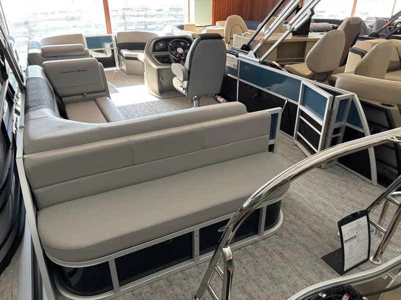 Slide: The Image of 2024 South Bay 200 Series S222CR2 pontoon boat interior with plush seating and modern dashboard. - 8