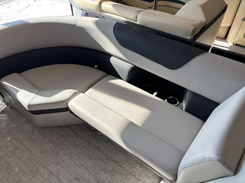 Slide: The Image of 2024 South Bay 200 Series S222CR2 boat interior with plush seating and cup holders. - 9
