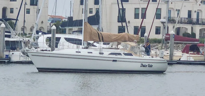 The Image of Sailboat Catalina 42 MkII 1995 docked in marina with buildings in background. - 0