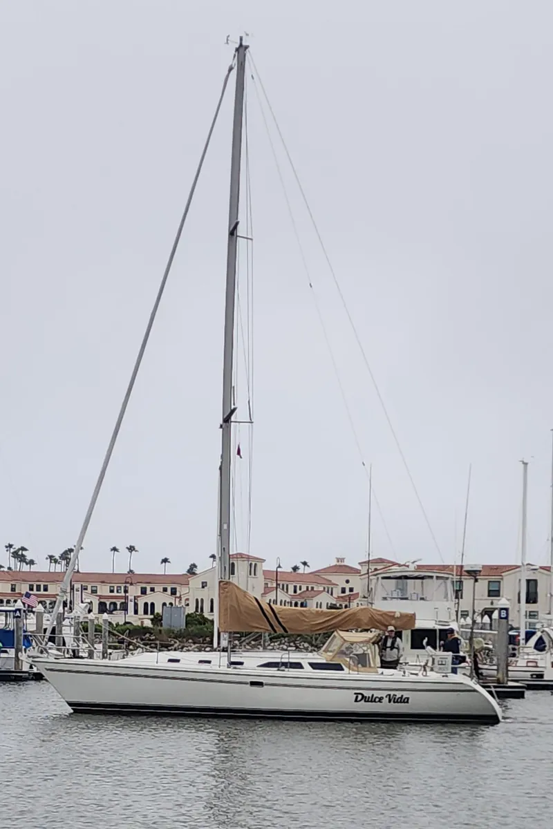 Slide: The Image of 1995 Catalina 42 MkII sailboat docked in marina, overcast sky. - 1