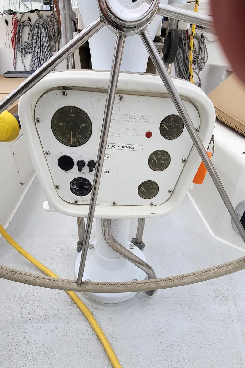 Slide: The Image of Steering console of a 1995 Catalina 42 MkII sailboat with gauges and controls. - 11