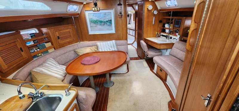 Slide: The Image of Interior of 1995 Catalina 42 MkII sailboat with cozy seating and wooden finishes. - 17