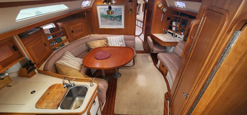 Slide: The Image of Interior of a 1995 Catalina 42 MkII sailboat with cozy seating and wooden finishes. - 19