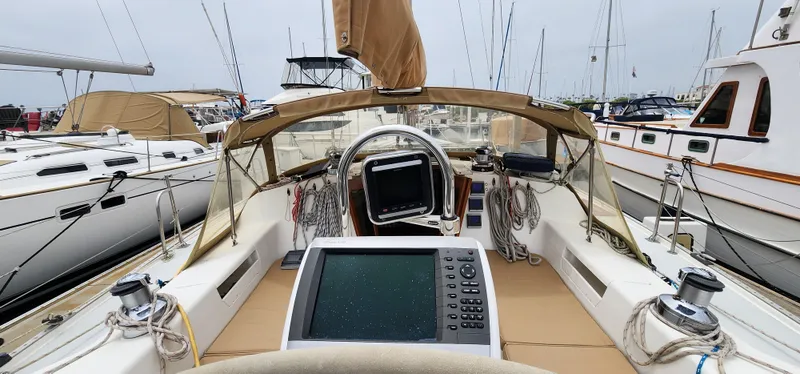 Slide: The Image of Cockpit view of a 1995 Catalina 42 MkII sailboat docked at a marina. - 2