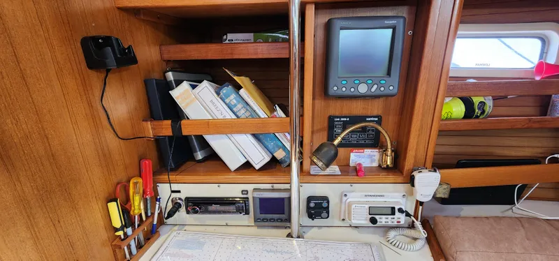 Slide: The Image of Navigation station on a 1995 Catalina 42 MkII sailboat with charts and instruments. - 21
