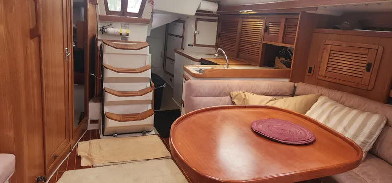 Slide: The Image of Interior of 1995 Catalina 42 MkII sailboat with wooden furnishings and cozy seating area. - 22