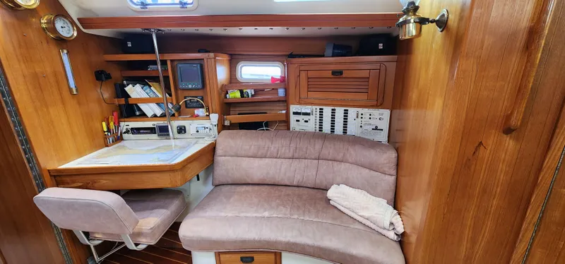 Slide: The Image of Interior of 1995 Catalina 42 MkII sailboat with navigation station and seating area. - 23