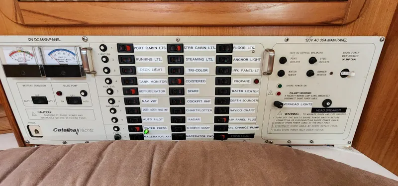 Slide: The Image of Electrical control panel of a 1995 Catalina 42 MkII sailboat, featuring various switches and gauges. - 25
