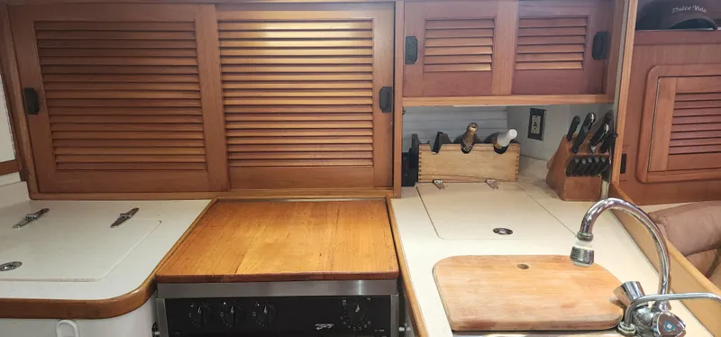 Slide: The Image of Galley kitchen in 1995 Catalina 42 MkII sailboat with wooden cabinets and countertop. - 27