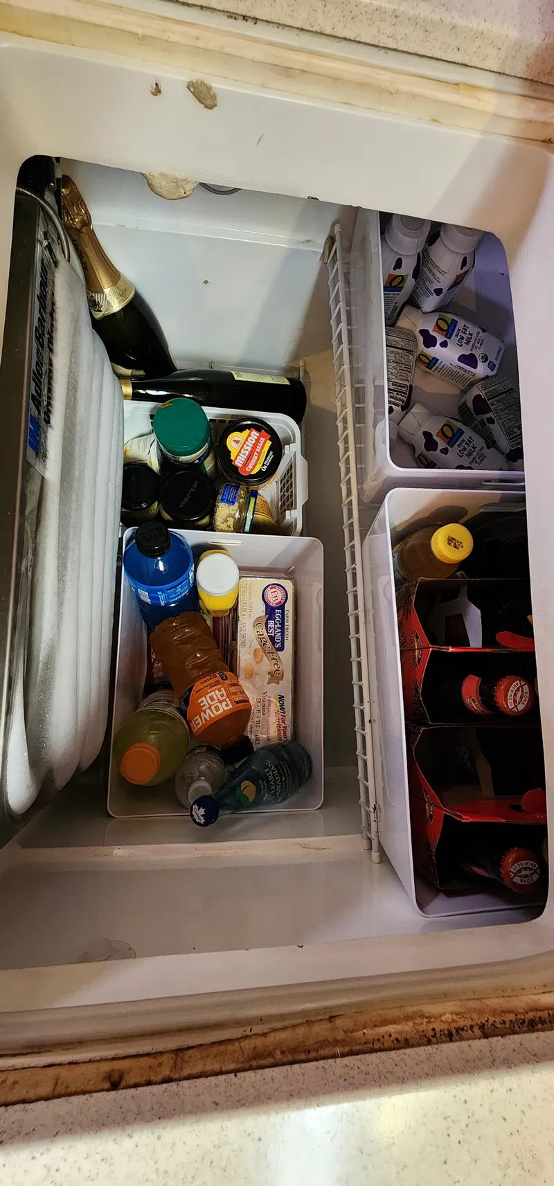 Slide: The Image of Refrigerator stocked with drinks and condiments on a 1995 Catalina 42 MkII boat. - 29