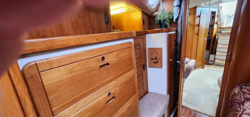 Slide: The Image of Interior of a 1995 Catalina 42 MkII sailboat with wooden cabinetry and cozy decor. - 34