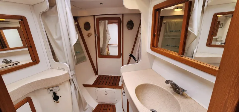 Slide: The Image of Interior of 1995 Catalina 42 MkII sailboat bathroom with sink and wooden accents. - 36