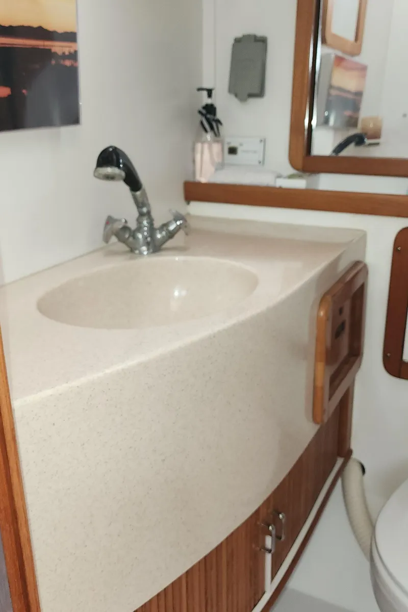 Slide: The Image of 1995 Catalina 42 MkII yacht bathroom with sink, faucet, and mirror. - 37