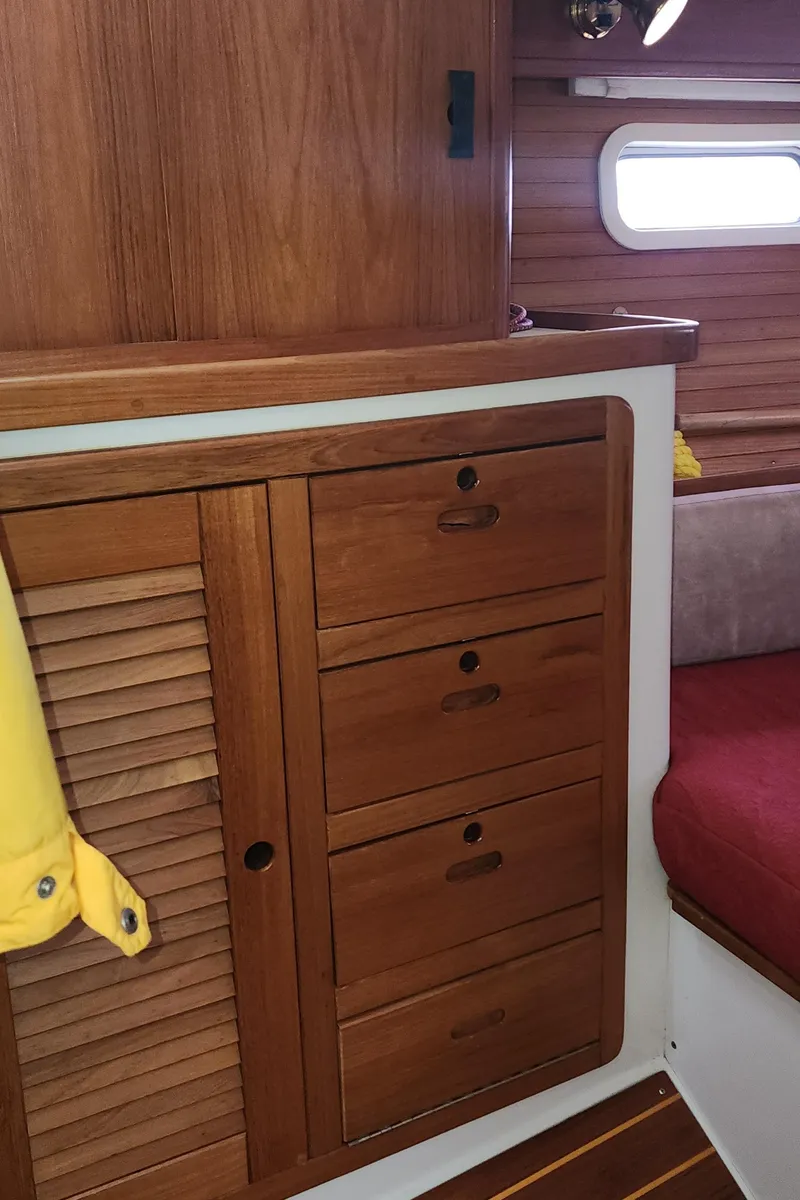 Slide: The Image of Wooden interior of a 1995 Catalina 42 MkII sailboat with storage cabinets and seating. - 41