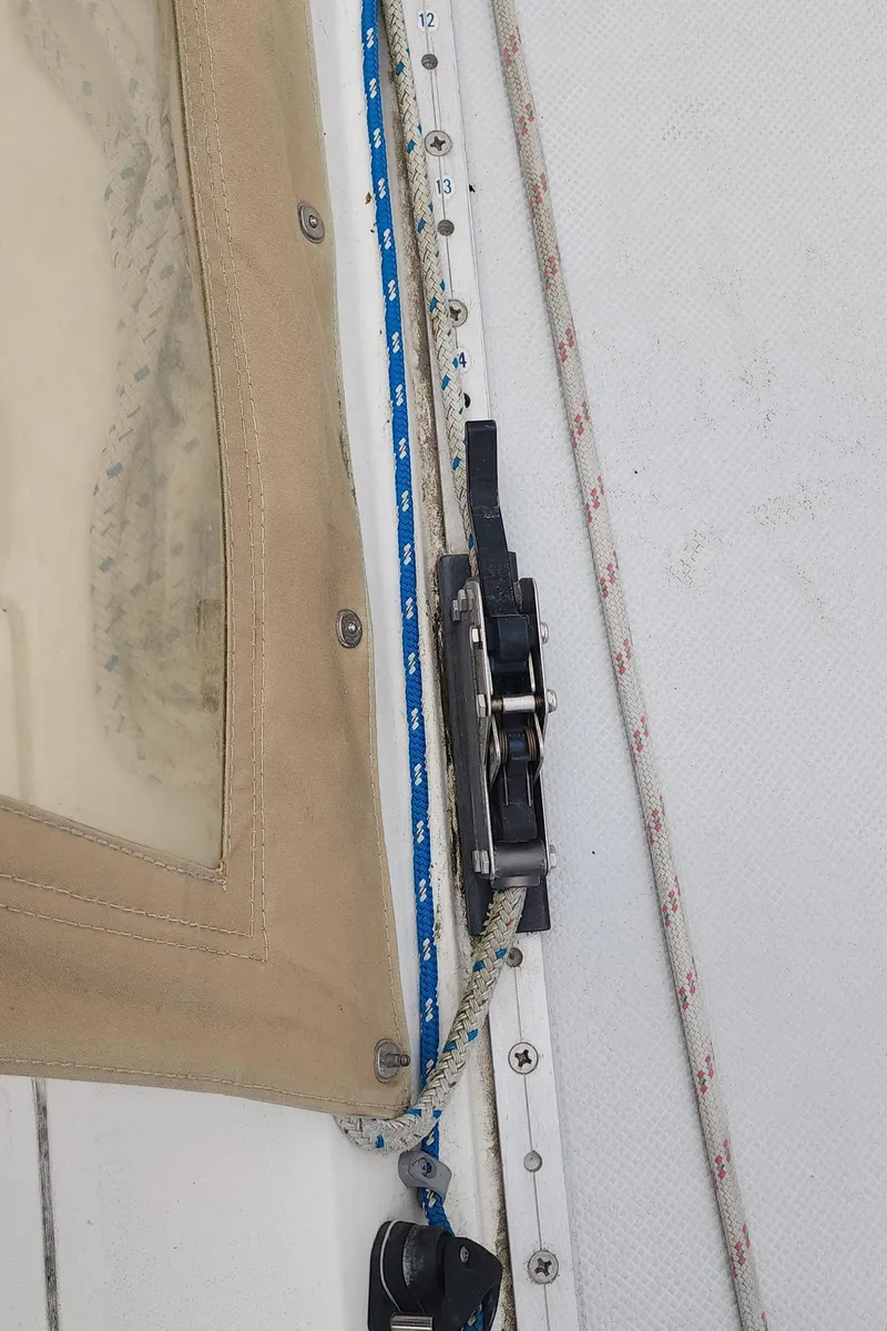 Slide: The Image of Close-up of Catalina 42 MkII sailboat rigging, featuring ropes and a pulley system. - 46